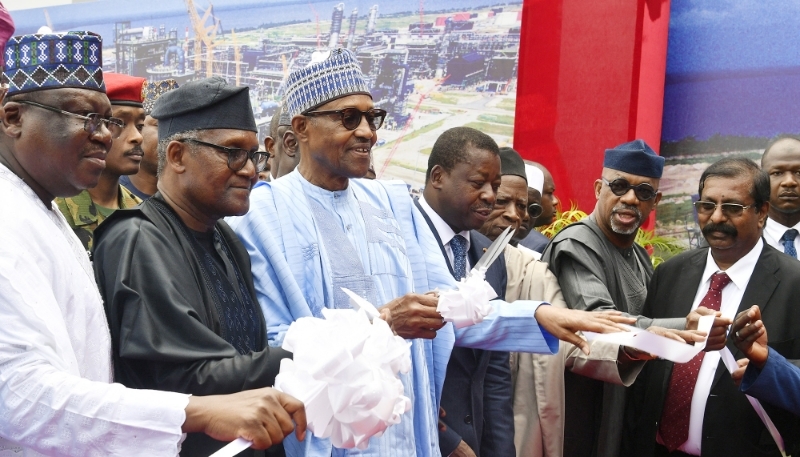 Le président nigérian Muhammadu Buhari (au centre), Aliko Dangote (à sa dr.) et le président togolais Faure Gnassingbé (à sa g.) à Lagos, le 22 mai 2023.